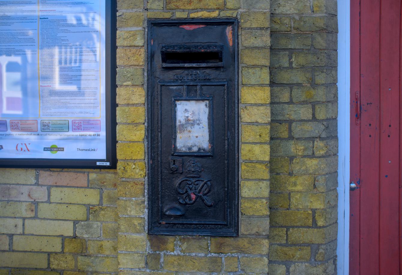 A black-painted post box, with no indication that it is currently in use.