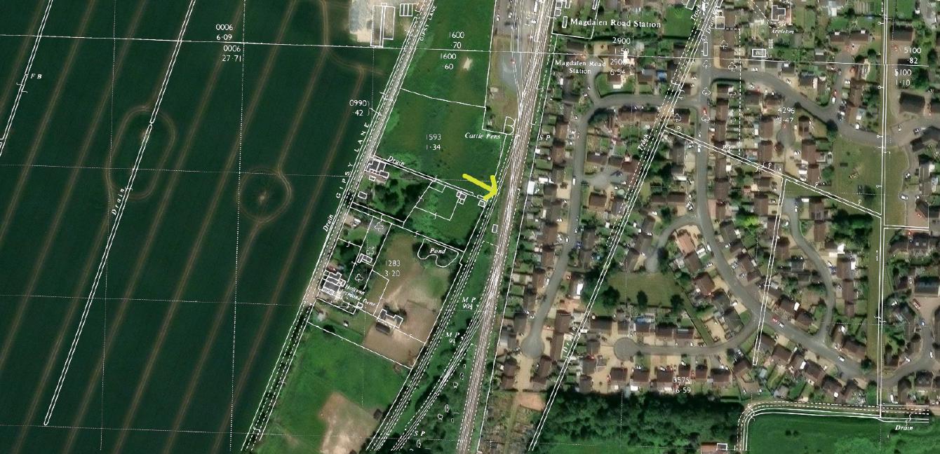 An old map overlaid onto modern satellite imagery with the location of a goods siding indicated.