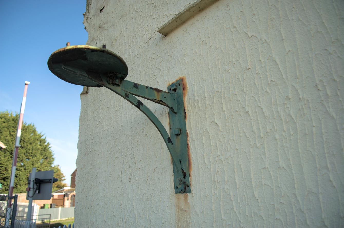A right-angle cast iron bracket with a circle for attachment of whatever went on top of it.