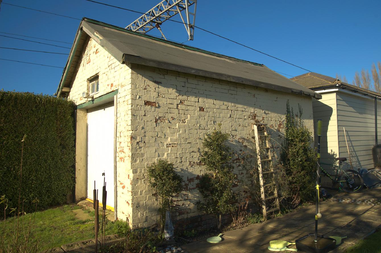 A view of the rear of the old store building; it is about one storey high, five metres long and 3.5 metres wide, brick, with some white/cream render.