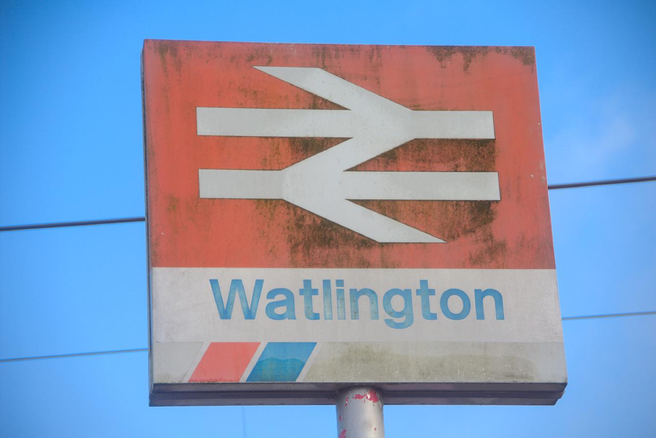 The station sign for Watlington, showing slightly-faded Network SouthEast branding.